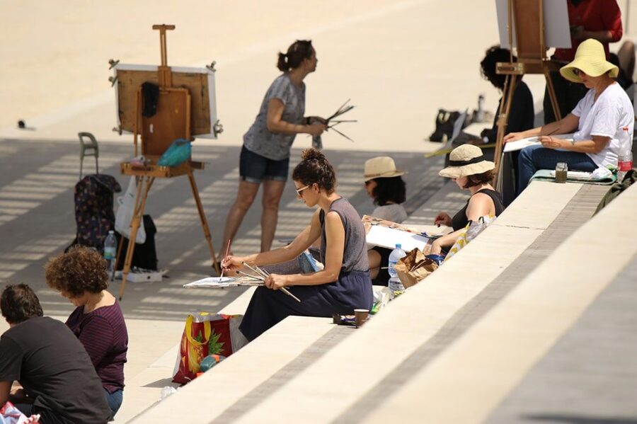 Artists sketching together outdoors in an urban setting