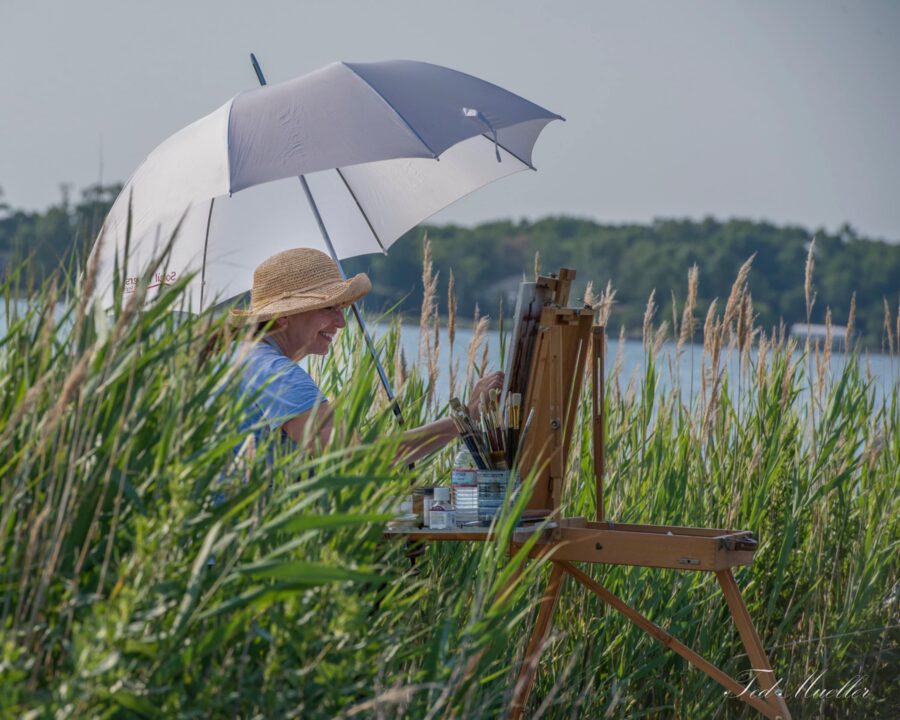 Artist painting outdoors at an easel